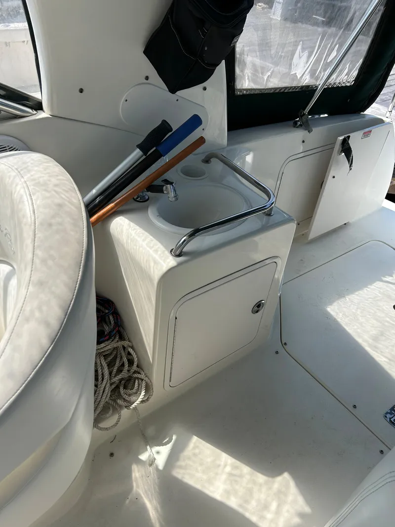 Slide: The Image of 2004 Sea Ray 260 DA boat interior with sink and storage compartment. - 4