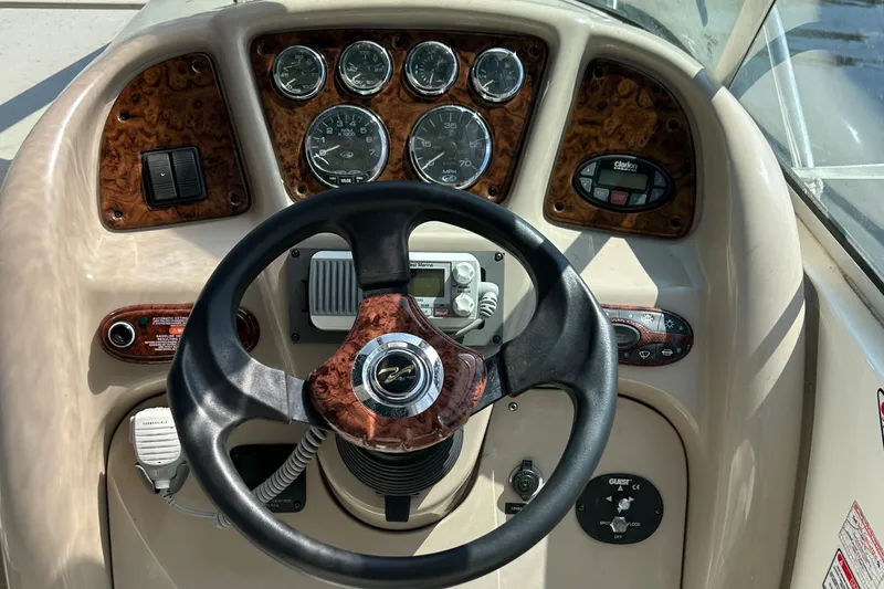 Slide: The Image of 2004 Sea Ray 260 DA boat dashboard with steering wheel and gauges. - 5