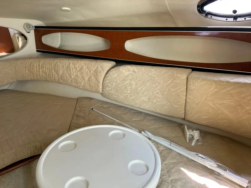 Slide: The Image of Interior cabin of 2004 Sea Ray 260 DA with beige upholstery and round table. - 7