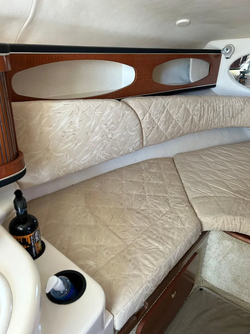 Slide: The Image of Interior cabin of 2004 Sea Ray 260 DA with beige upholstery and wooden accents. - 8
