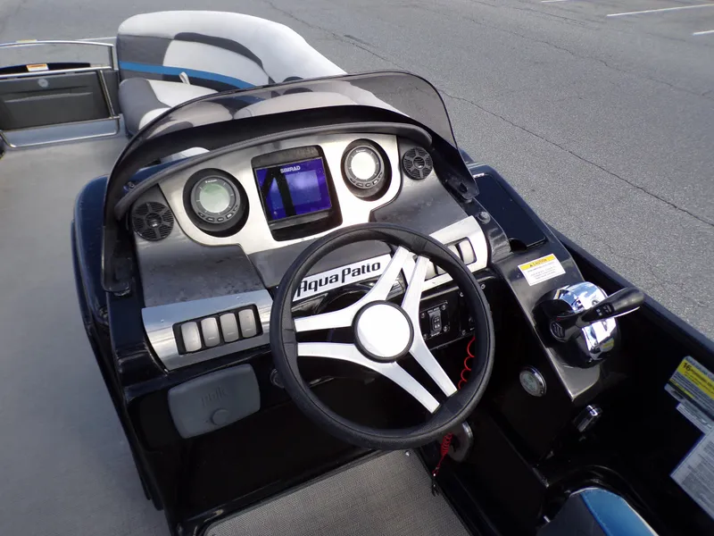 Slide: The Image of 2018 Godfrey Aqua Patio 250 XP boat dashboard with steering wheel and control panel. - 10