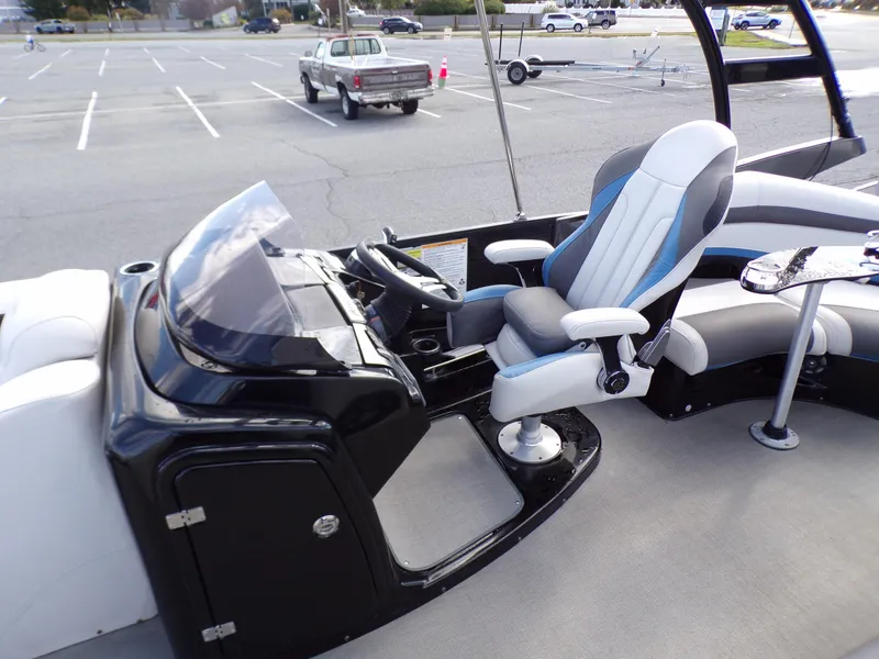 Slide: The Image of 2018 Godfrey Aqua Padio 250 XP boat interior with captain's chair and control console. - 9