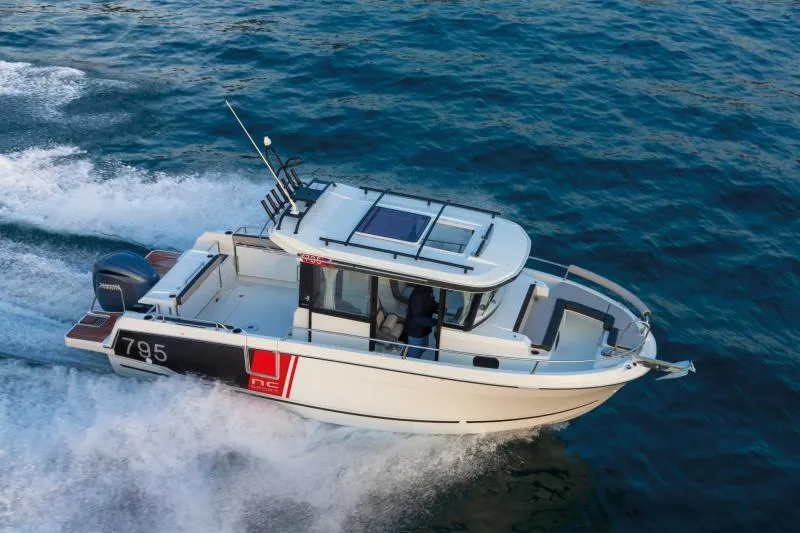 Slide: The Image of 2024 Jeanneau NC 795 Series 2 boat cruising on open water. - 1