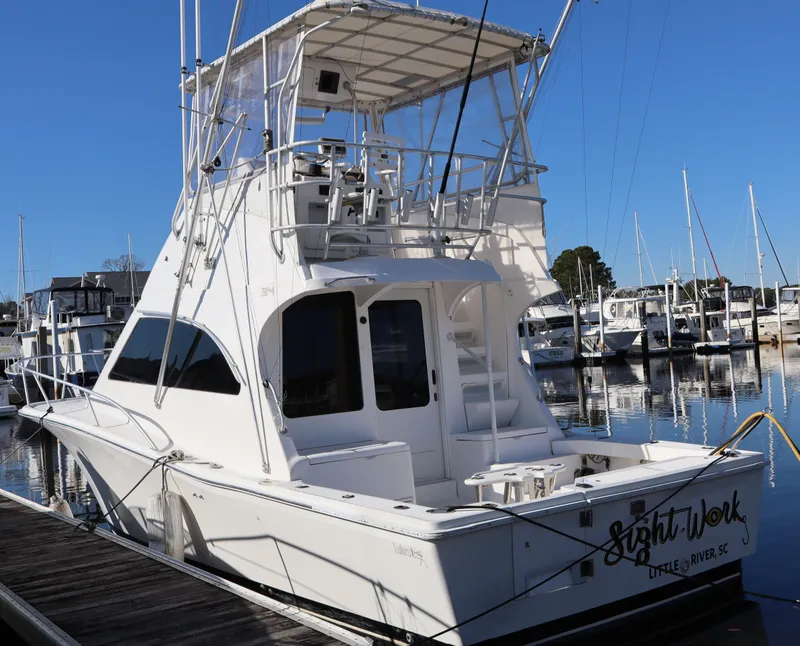 The Image of 2002 Luhrs 34 Convertible yacht docked at marina, rear view. - 0