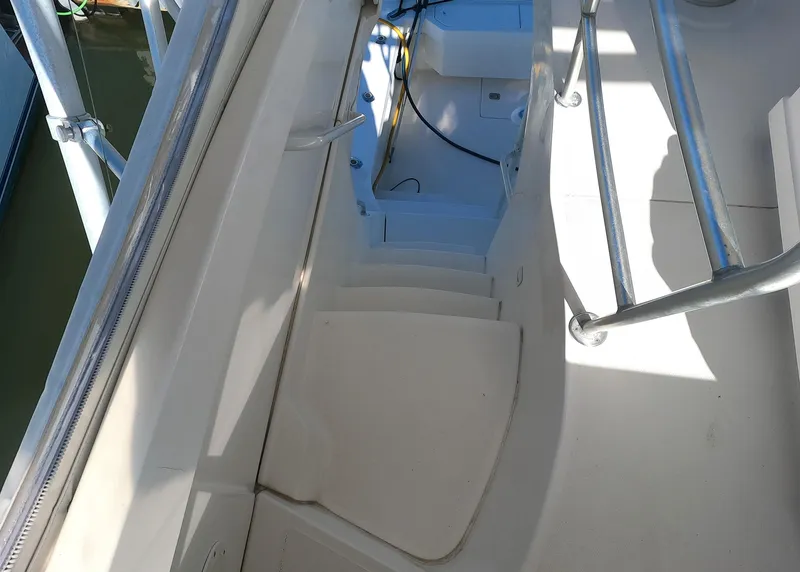 Slide: The Image of 2002 Luhrs 34 Convertible boat stairs and deck area. - 13