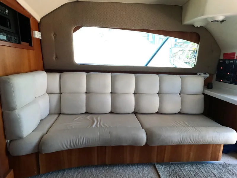 Slide: The Image of Interior of 2002 Luhrs 34 Convertible boat with beige cushioned seating. - 19