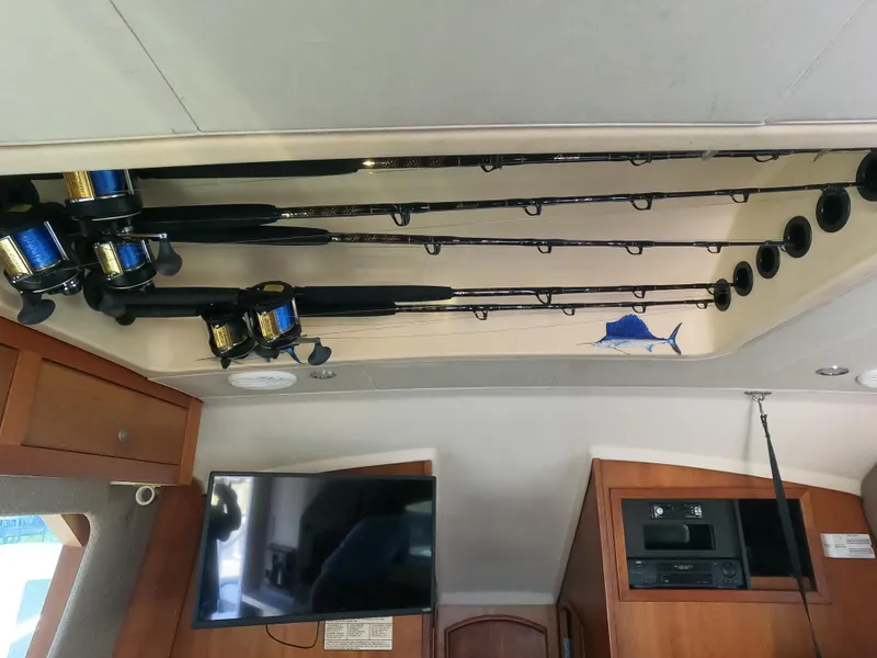 Slide: The Image of Fishing rods stored on the ceiling of a 2002 Luhrs 34 Convertible boat interior. - 23