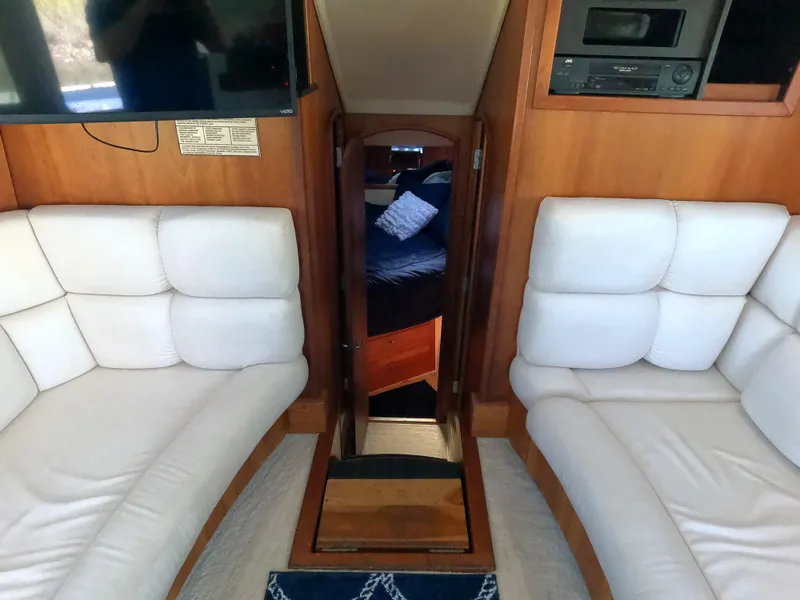 Slide: The Image of Interior of 2002 Luhrs 34 Convertible yacht with white seating and wood accents. - 27