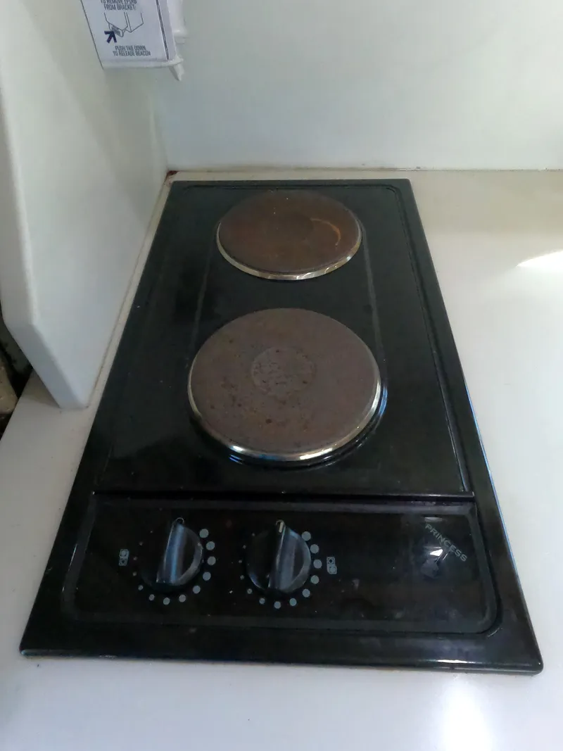 Slide: The Image of Two-burner electric stove in a 2002 Luhrs 34 Convertible boat kitchen. - 30