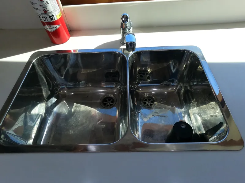 Slide: The Image of 2002 Luhrs 34 Convertible boat kitchen sink with dual basins and faucet. - 31