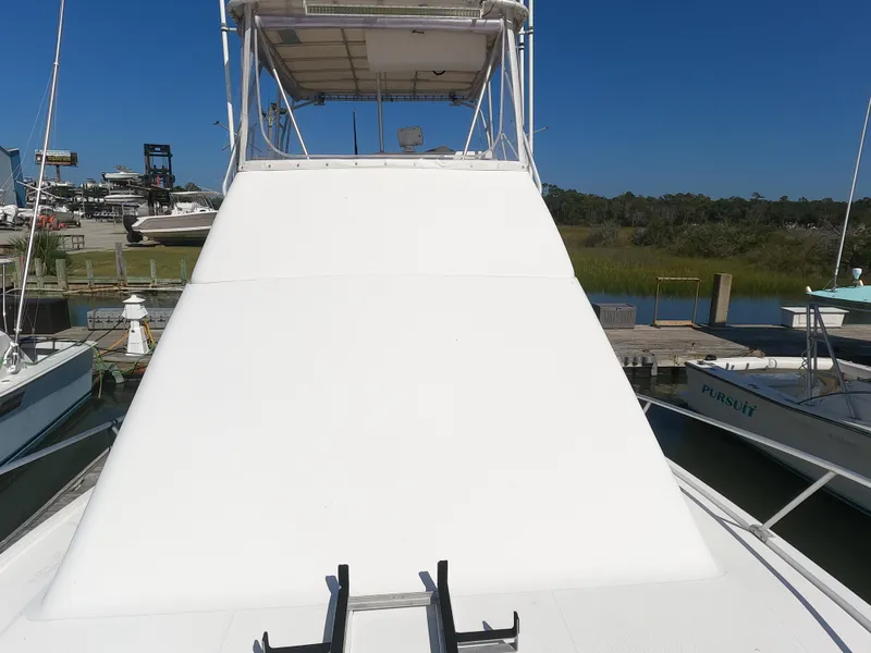 Slide: The Image of 2002 Luhrs 34 Convertible boat docked at a marina. - 4