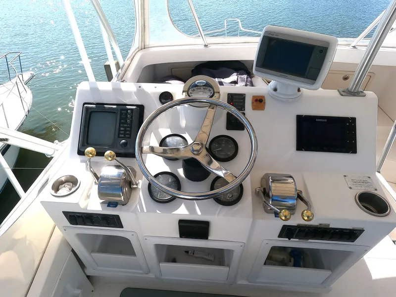 Slide: The Image of 2002 Luhrs 34 Convertible boat helm with navigation equipment and steering wheel. - 6