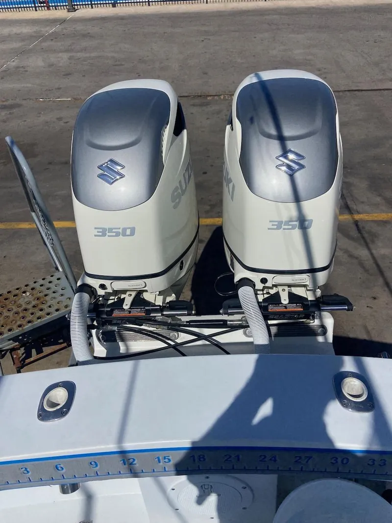 Slide: The Image of 2004 Mirage 32 boat with twin Suzuki 350 outboard engines. - 12
