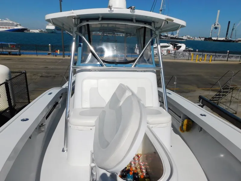 Slide: The Image of 2004 Mirage 32 boat with open storage compartment at dock. - 22