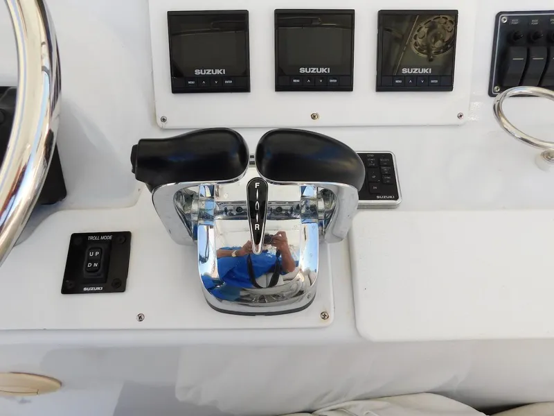 Slide: The Image of Boat control panel of a 2004 Mirage 32 with Suzuki engine controls. - 30