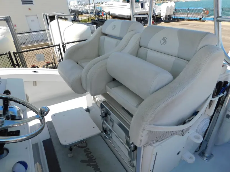 Slide: The Image of Luxurious seating on a 2004 Mirage 32 boat with a marina background. - 34