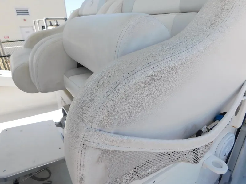 Slide: The Image of Close-up of white leather boat seats on a 2004 Mirage 32. - 35