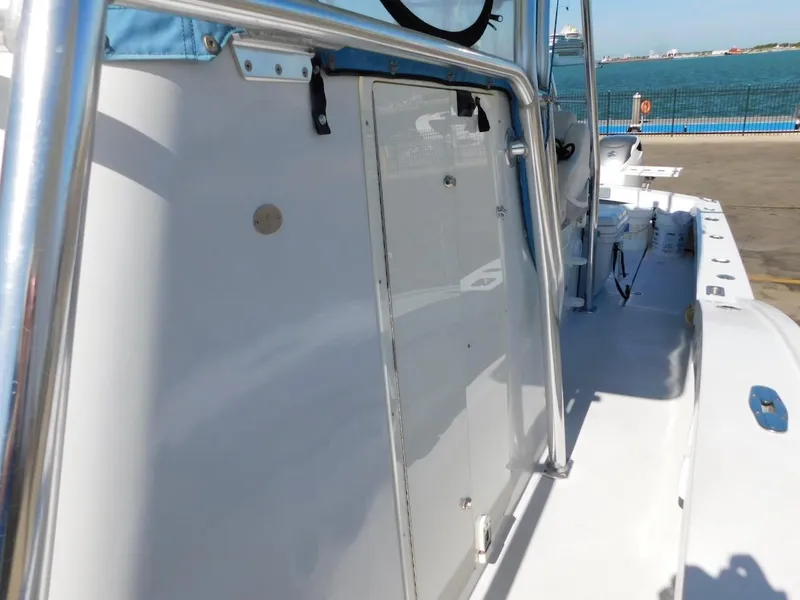 Slide: The Image of 2004 Mirage 32 boat side view at dock with ocean background. - 36