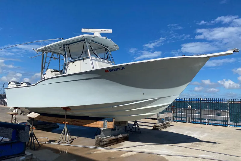 Slide: The Image of 2004 Mirage 32 boat on dry dock with blue sky background. - 4