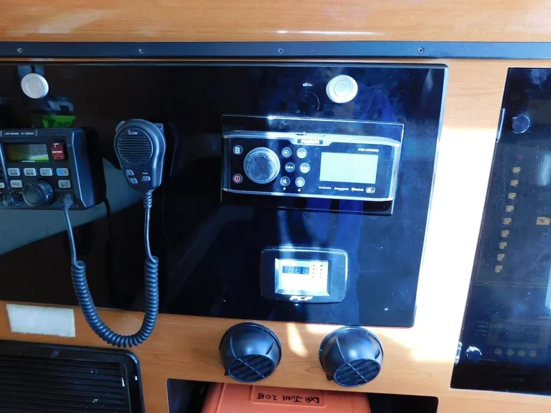 Slide: The Image of Boat control panel of a 2004 Mirage 32 with radio and microphone. - 41