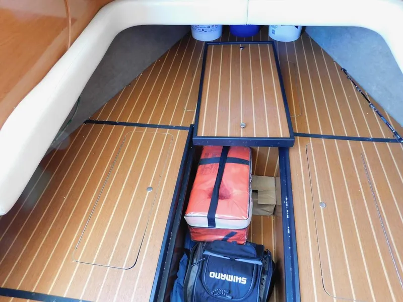 Slide: The Image of Interior storage area of a 2004 Mirage 32 boat with wooden flooring. - 45