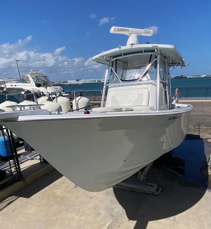 Slide: The Image of 2004 Mirage 32 boat docked at a marina on a sunny day. - 6
