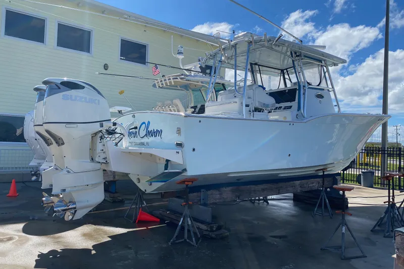 Slide: The Image of 2004 Mirage 32 boat with Suzuki engines on a lift. - 9