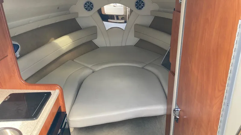 Slide: The Image of Interior cabin of a 2007 Rinker 270 Express Cruiser with seating and kitchenette. - 10