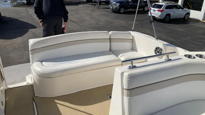 Slide: The Image of 2007 Rinker 270 Express Cruiser interior with white seating and beige flooring. - 4