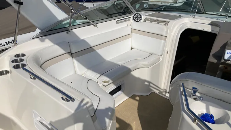 Slide: The Image of 2007 Rinker 270 Express Cruiser interior seating area with white upholstery. - 5