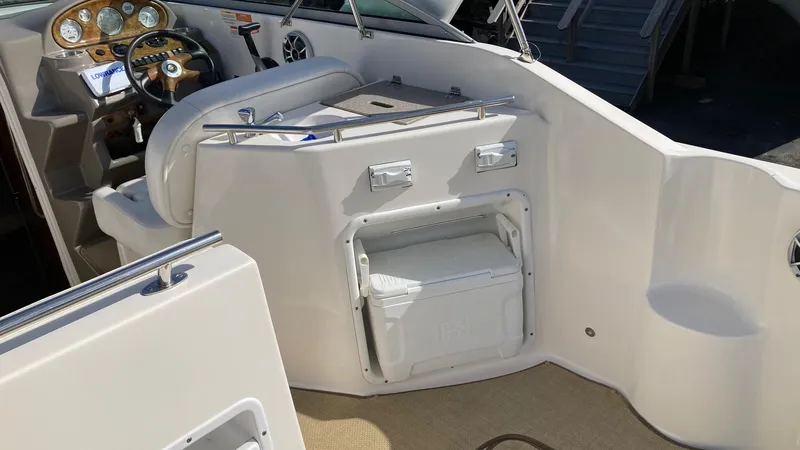 Slide: The Image of 2007 Rinker 270 Express Cruiser cockpit with helm and seating area. - 6