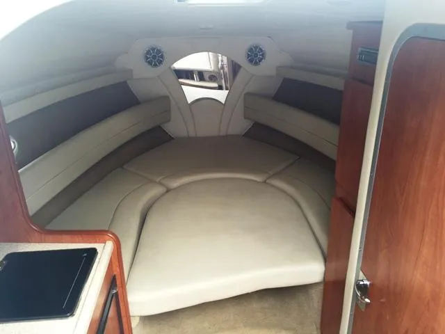 Slide: The Image of Interior cabin of a 2007 Rinker 270 Express Cruiser with beige seating. - 9