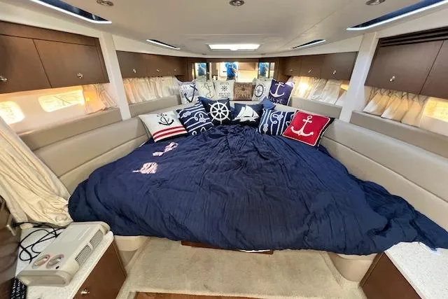 Slide: The Image of Luxurious 2014 Sea Ray Sundancer 350 cabin with nautical-themed bedding and decor. - 10