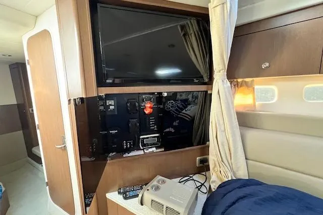 Slide: The Image of Interior of 2014 Sea Ray Sundancer 350 with TV, control panel, and cozy seating area. - 11