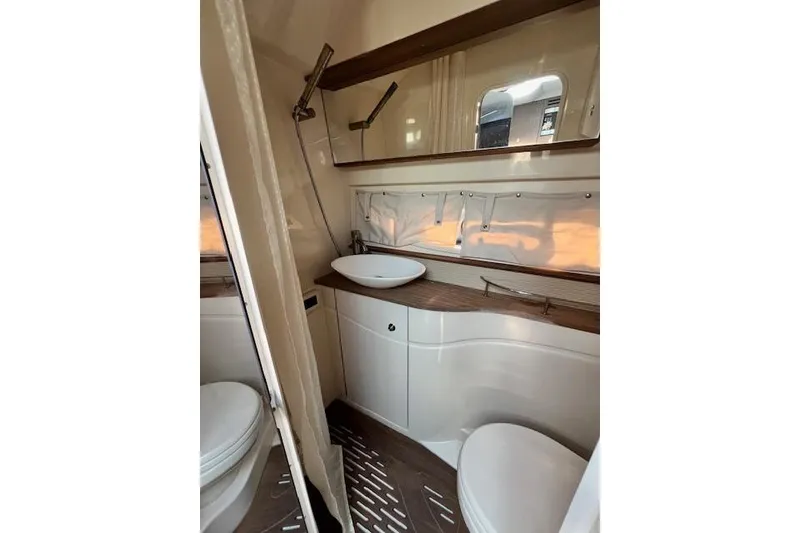 Slide: The Image of 2014 Sea Ray Sundancer 350 bathroom with modern fixtures and sleek design. - 18