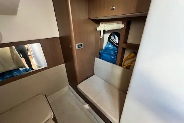 Slide: The Image of 2014 Sea Ray Sundancer 350 cabin interior with seating and storage compartments. - 19