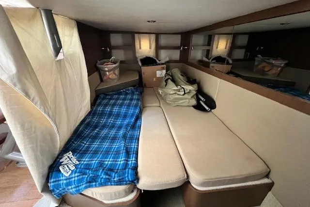 Slide: The Image of 2014 Sea Ray Sundancer 350 cabin interior with cozy seating and storage. - 20