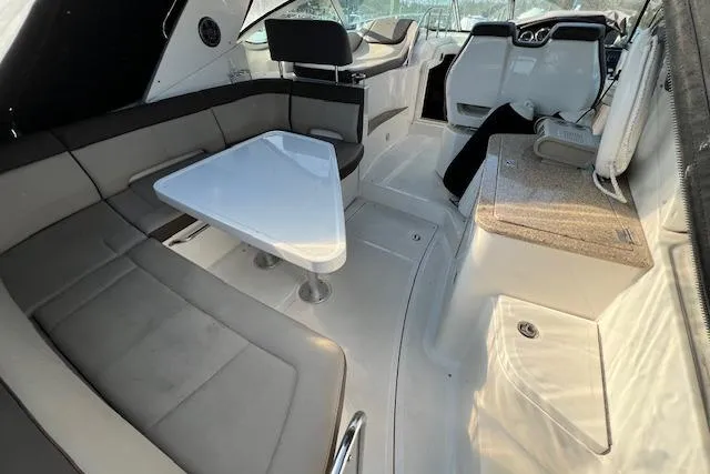 Slide: The Image of 2014 Sea Ray Sundancer 350 interior with seating, table, and helm. - 24