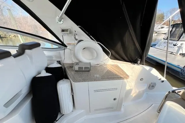 Slide: The Image of 2014 Sea Ray Sundancer 350 interior with seating, storage, and marine equipment. - 26