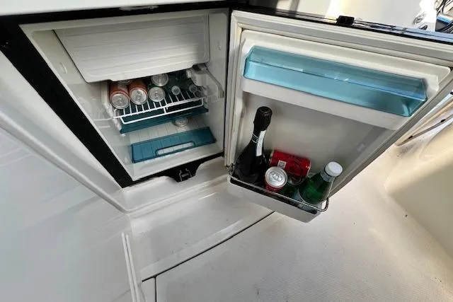 Slide: The Image of Open fridge on 2014 Sea Ray Sundancer 350 yacht, stocked with drinks and beverages. - 27