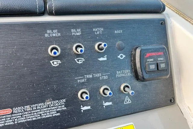 Slide: The Image of Control panel of a 2014 Sea Ray Sundancer 350 boat with various switches and warnings. - 4