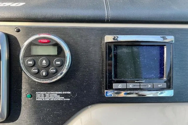 Slide: The Image of Control panel of a 2014 Sea Ray Sundancer 350 boat with audio and navigation systems. - 5