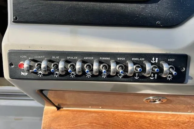 Slide: The Image of Control panel of a 2014 Sea Ray Sundancer 350 boat with labeled switches. - 7