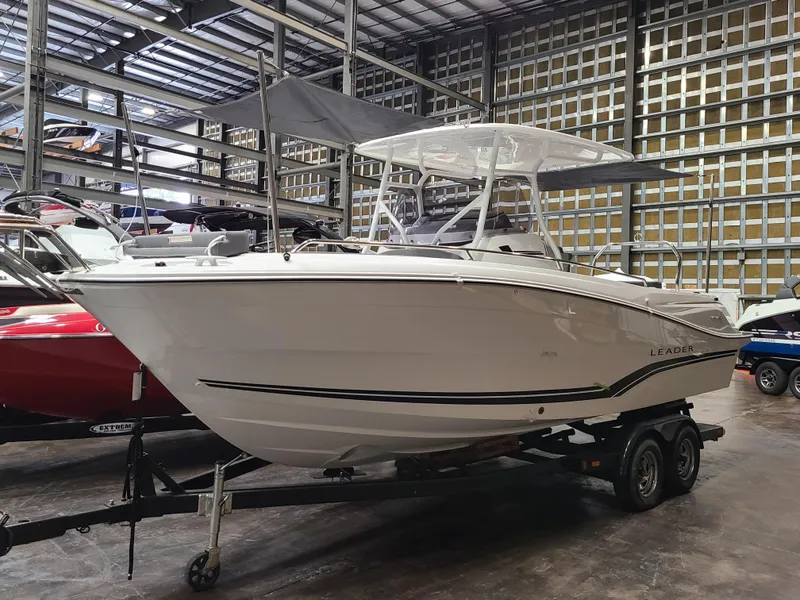 Slide: The Image of 2024 Jeanneau Leader 7.5 WA boat on trailer in storage facility. - 0