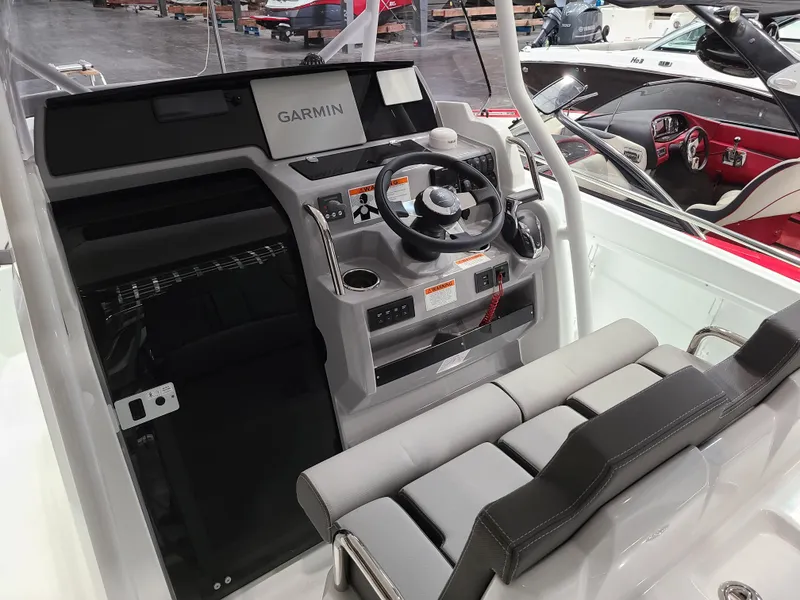 Slide: The Image of 2024 Jeanneau Leader 7.5 WA boat cockpit with Garmin navigation system. - 2
