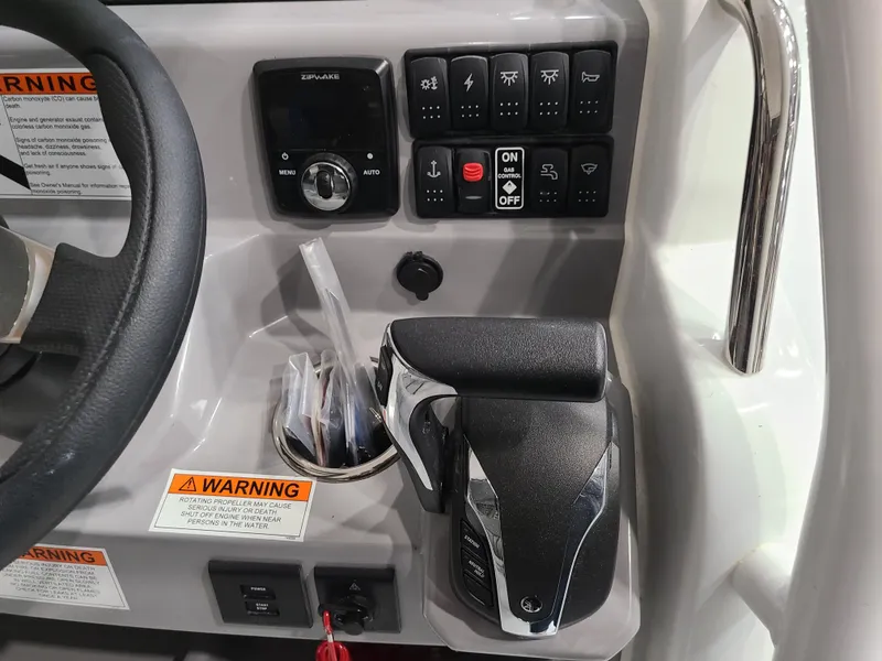 Slide: The Image of Control panel of 2024 Jeanneau Leader 7.5 WA boat with throttle and warning labels. - 4