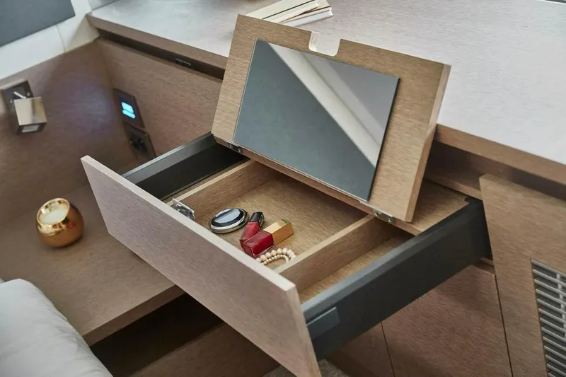Slide: The Image of Prestige 420 Fly 2024 yacht interior drawer with mirror and accessories. - 12
