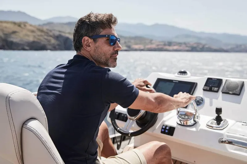 Slide: The Image of Man piloting 2024 Prestige 420 Fly yacht on a sunny day. - 4
