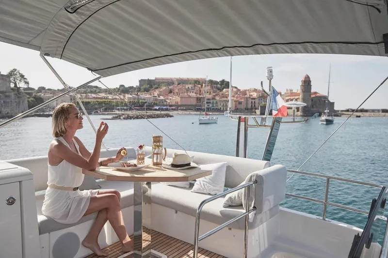 Slide: The Image of Woman relaxing on 2024 Prestige 420 Fly yacht, enjoying coastal view. - 6