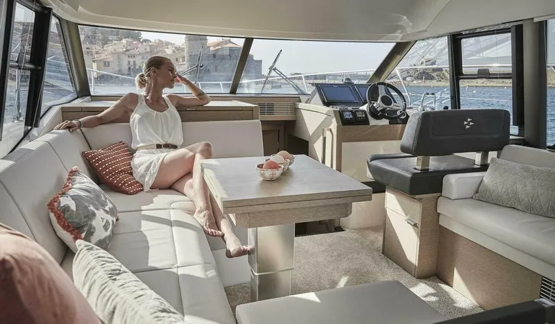 Slide: The Image of Woman relaxing in the luxurious interior of a 2024 Prestige 420 Fly yacht. - 7